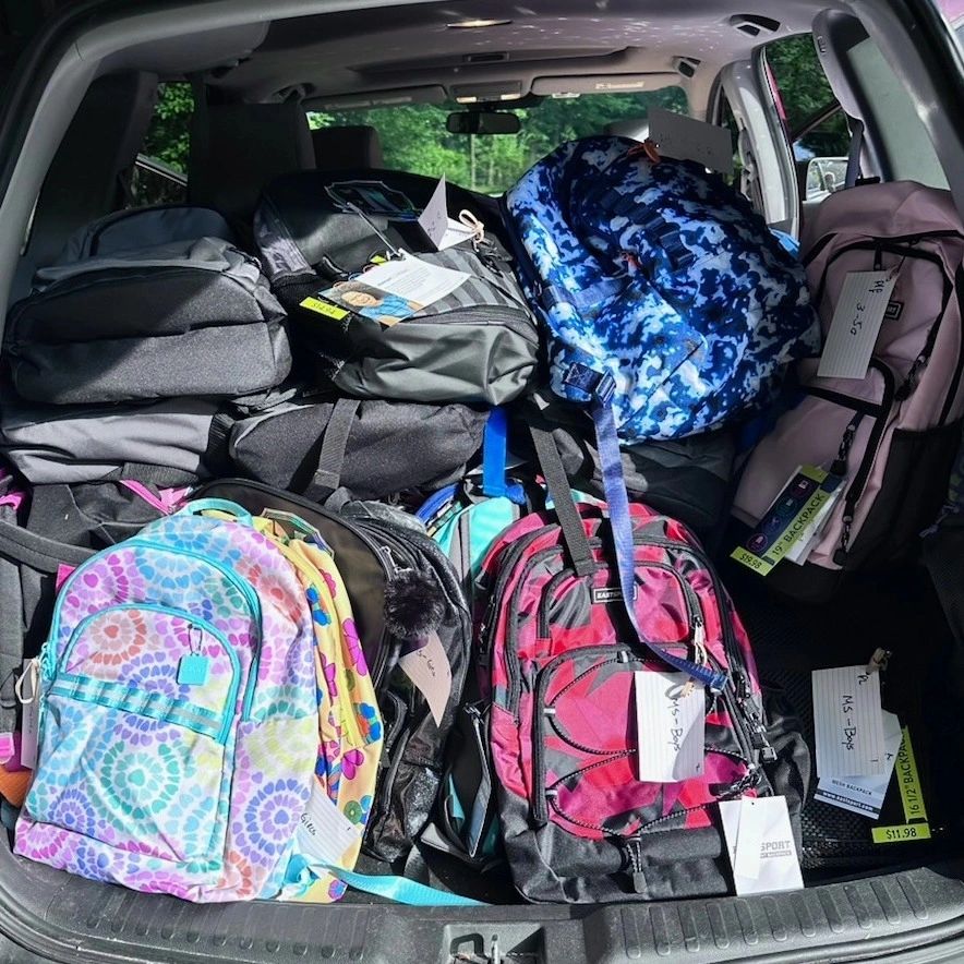 An SUV loaded with donated backpacks